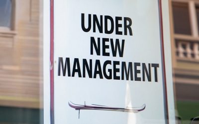 Under New Management sign on window